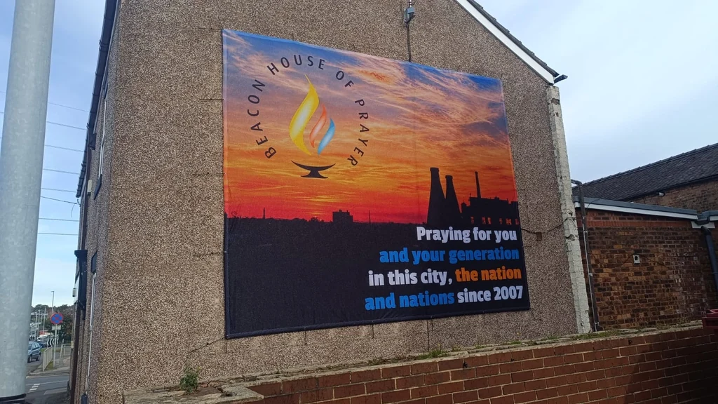 Completed Beacon House of Prayer building graphic with sunset artwork and a pottery skyline